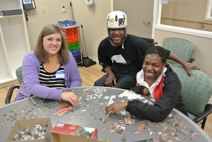 Chris, LaQuita, and I working on a puzzle.