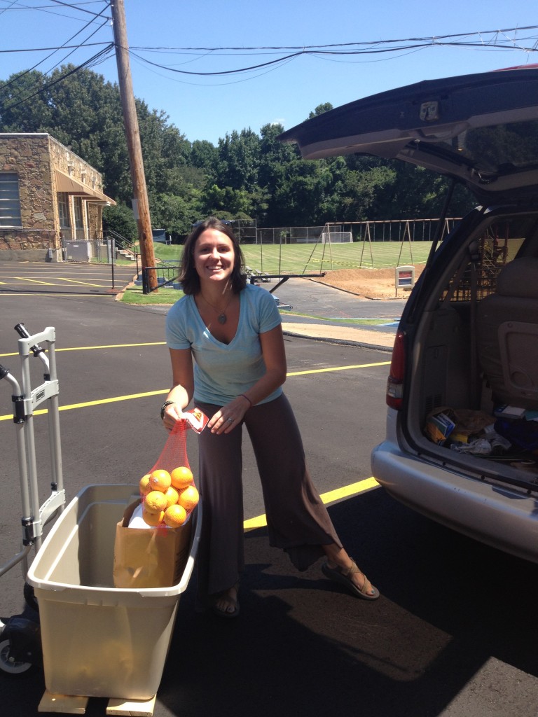 Loading a family's portion of fruit with Catholic Charities Mobile Food Pantry