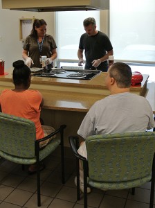 Michael demonstrates how to make muffins in the SRVS Learning Center kitchen.