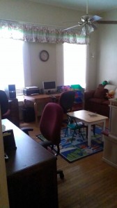 The office/play room downstairs. This space allows the family to search for jobs online while letting their little ones play. 