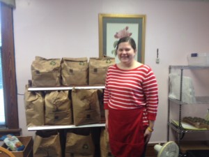 Standing up front preparing to hand out food parcels at the Fig Tree Food Pantry (with a smile!)