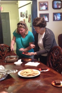 Sister Maureen and another volunteer cut in to a dessert to share.