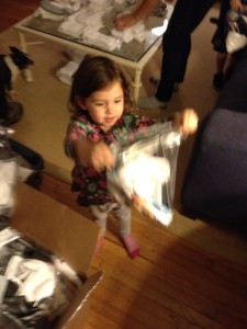 Ella helps assemble survival kits