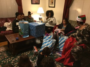 Families unwrapping holiday presents donated by generous volunteers!